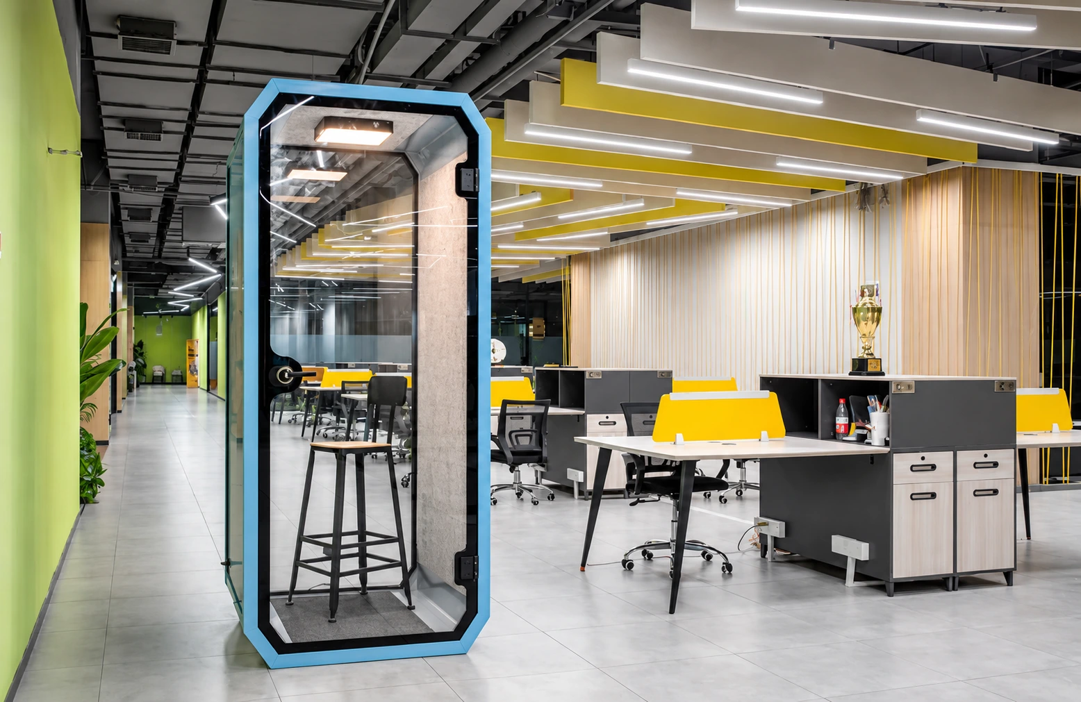 Phone booth beside open-plan desks