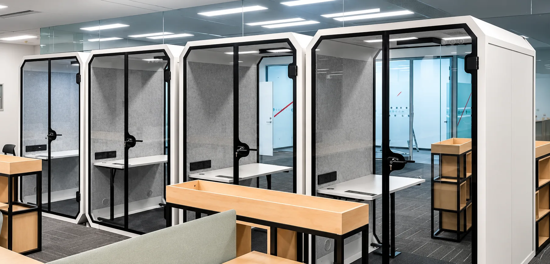 Row of work pods in an open-plan office